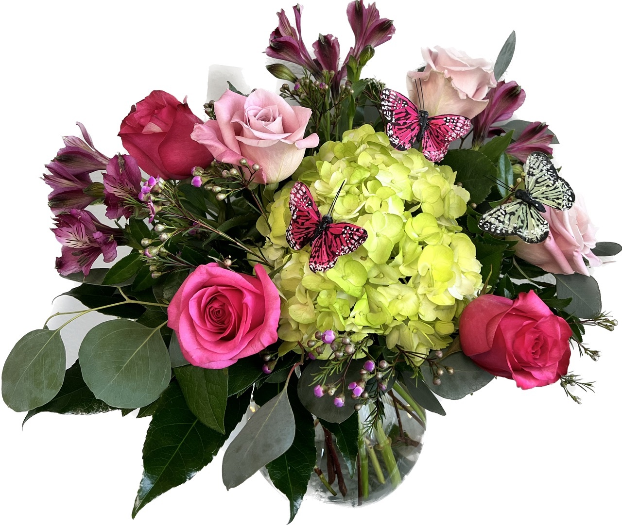Colorful floral arrangement featuring roses, hydrangeas, and pink butterflies nestled among green leaves.