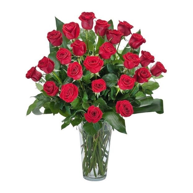 Elegant bouquet of long-stemmed red roses arranged with greenery in a tall clear glass vase.