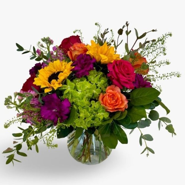 A vibrant bouquet of summer flowers bursting with juicy, mouth-watering colors in shades of red, orange, yellow, and pink.